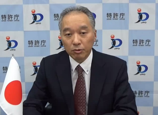 （Photo-1）Mr. KATSURA, Deputy Commissioner, delivers a video message